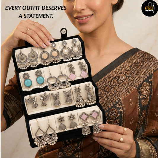 Woman styling a 12-pair oxidised silver-tone earrings collection with a velvet organiser box