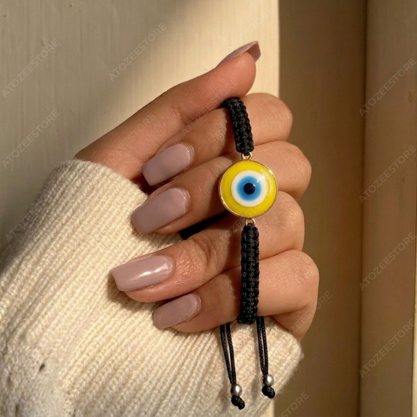 Yellow Evil Eye Black Cord Bracelet held in hand - Wear Protection Feel Powerful - Atozee Store
