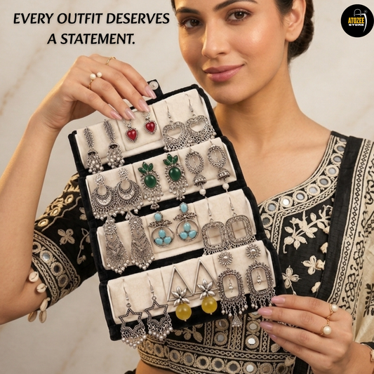 12 pairs of oxidised silver-tone earrings displayed in a velvet organiser box