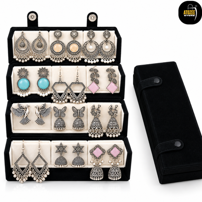 12 pairs of oxidised silver-tone earrings displayed in a velvet organiser box with a matching storage case