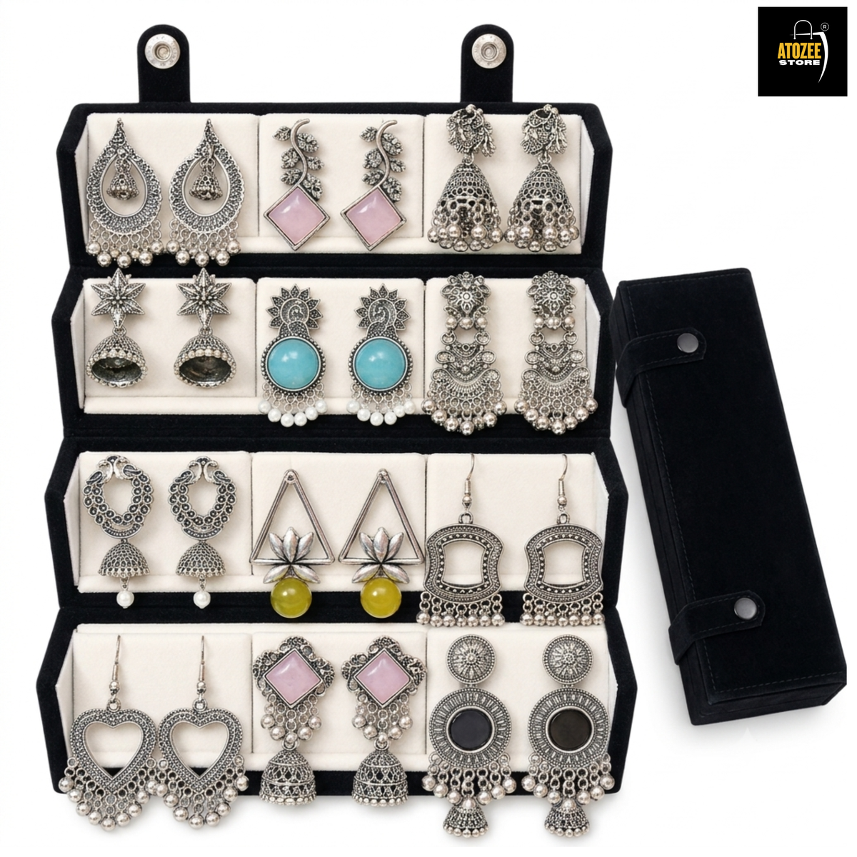 12 pairs of oxidised silver-tone jhumka and statement earrings displayed in a black velvet organiser box