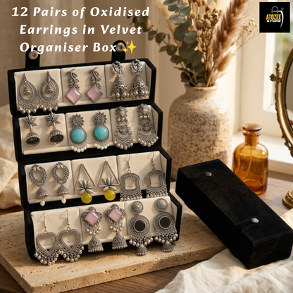 Woman holding a 12-pair oxidised silver-tone earrings collection with a velvet organiser box