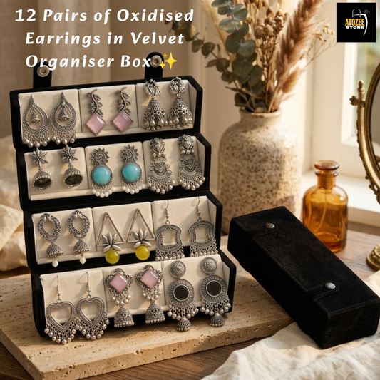 Woman holding a 12-pair oxidised silver-tone earrings collection with a velvet organiser box