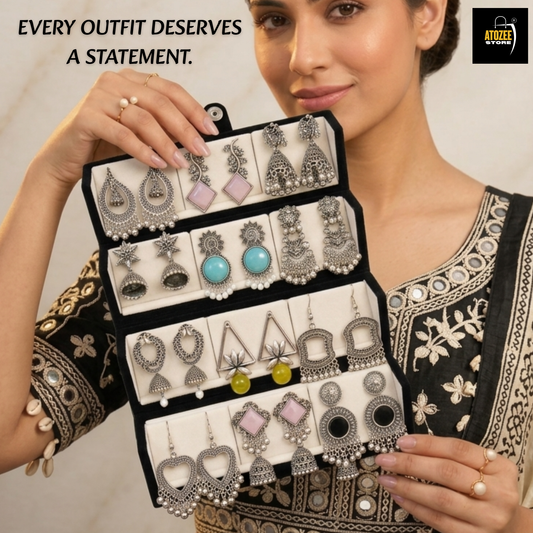 Oxidised silver-tone earrings and black velvet organiser box styled in a festive home display
